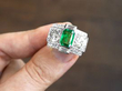 Displaying Octagonal Cut Emerald and Diamond Ring in Platinum