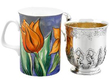 Georgian Silver Christening Mug next to a mug