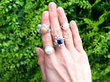gemstone rings on hand outside