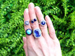 gemstone rings on hand outside