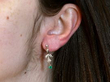 wearing emerald and diamond earring
