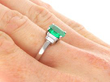 Emerald Ring with Baguette Diamonds in Platinum on hand