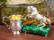 silver horse ornament next to a silver mug