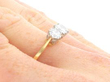 gold Round Brilliant Cut Trilogy Ring on Finger