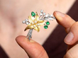 showcasing a Vintage Emerald and Pearl Flower Brooch