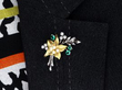 wearing a Vintage Emerald and Pearl Flower Brooch