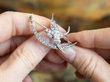 holding a Victorian swallow brooch