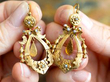 Holding Antique Pearl Drop Earrings in Gold