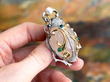 Holding a Scarab Beetle Brooch with Gemstones
