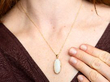 wearing 7.34 Carat Cabochon Opal Pendant in Gold