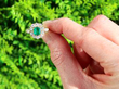 Vintage Emerald and Diamond Cluster Ring in Gold outside