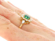 Vintage Emerald and Diamond Cluster Ring in Gold on hand