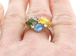 Green Orange and Blue Sapphire Ring in Gold on finger