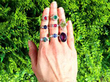 gemstone rings on hand outside