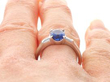 Oval Sapphire Ring with Diamond Shoulders on finger