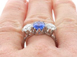 Cushion Cut Sapphire Trilogy Ring in Platinum on finger
