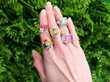 gemstone rings on hand outside