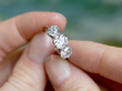 holding 3 Carat Three Stone Diamond Ring