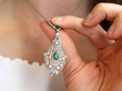 Antique Pearl and Emerald Pendant with Diamonds being worn