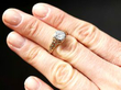 Bezel Set Round Engagement Ring in Gold on finger
