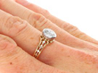 Bezel Set Round Engagement Ring in Gold on hand