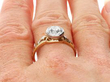 Bezel Set Round Engagement Ring in Gold being worn