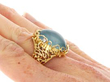 Naturalistic Cabochon Aquamarine Ring in Yellow Gold on hand
