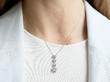 wearing 4 Diamond Drop Pendant Necklace in Platinum
