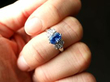 Oval Sapphire Ring with Baguette Diamonds on finger