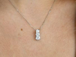 wearing three stone diamond platinum pendant