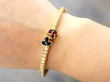 ruby sapphire diamond yellow gold bangle on wrist