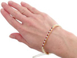 wearing ruby diamond bangle in gold