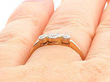 Three Stone Diamond Ring in Yellow Gold Wearing Finger