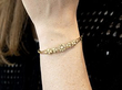 pearl and gold bangle on wrist
