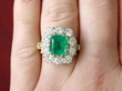 Large Emerald and Diamond Cluster Ring on finger