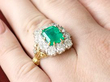 emerald and diamond cluster on hand