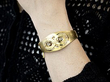 wearing a gold and diamond bangle
