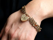 wearing a gold citrine bracelet with heart clasp