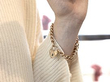 wearing a gold padlock bracelet
