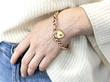 wearing a gold padlock bracelet