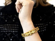 wearing gold opal bangle on wrist