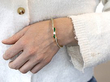 wearing emerald gold bangle