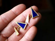 holding lapis lazuli cufflinks