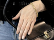 wearing a gold diamond and pearl bracelet