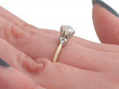 high set diamond engagement ring on hand