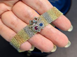 holding gold mesh bracelet