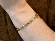 wearing gold and ruby bracelet