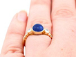 sapphire cabochon ring with diamonds wearing