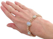 wearing opal bracelet in gold