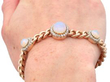 opal and gold bracelet on the hand